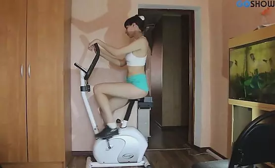 Fit Brunette Rides Stationary Bike to Pleasure