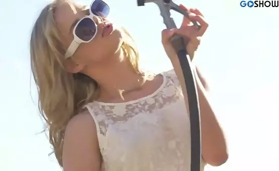 The tantalizing blonde delights in summer heat